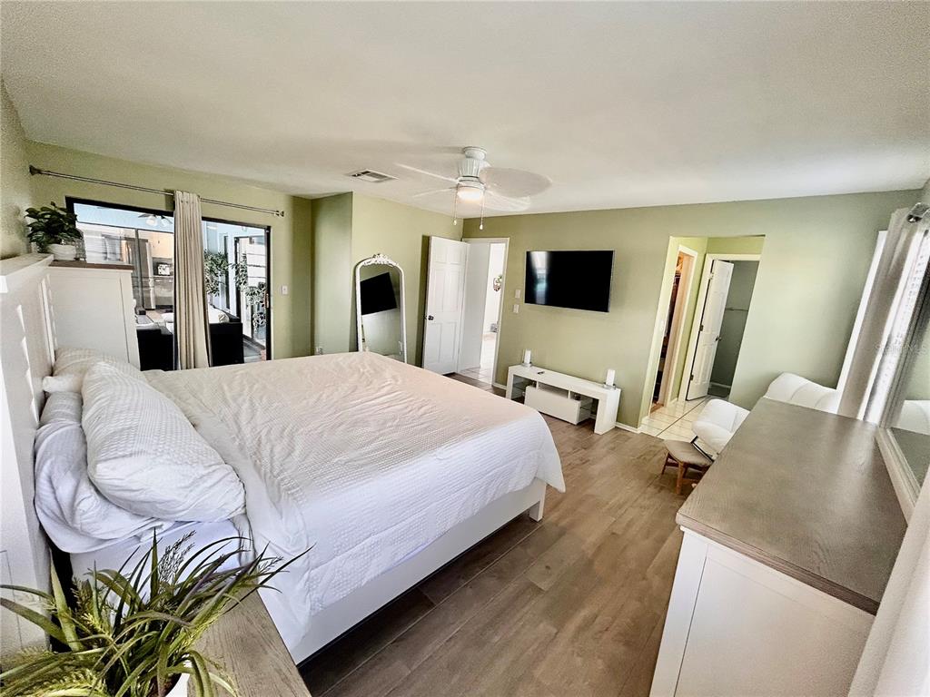 8911 Welsh Way Hudson, FL 34667 - Photo 16 of 33 a large bedroom with a bed and flat screen tv