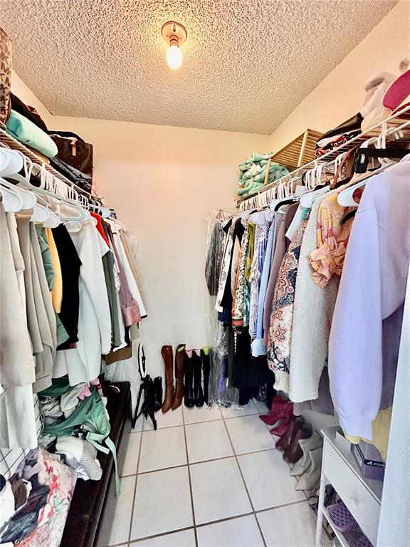 8911 Welsh Way Hudson, FL 34667 - Photo 19 of 33 a view of walk in closet with clothes and shoes