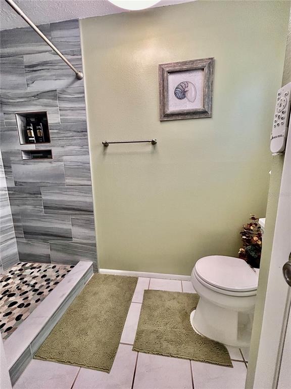 8911 Welsh Way Hudson, FL 34667 - Photo 20 of 33 a bathroom with a toilet and a shower