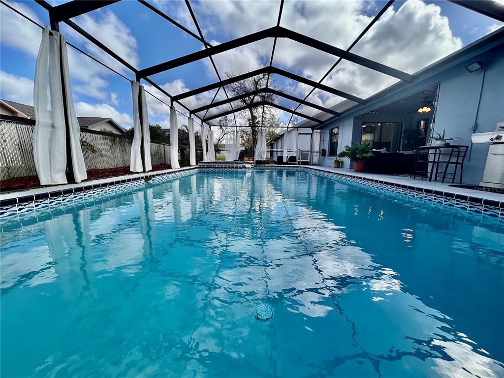 8911 Welsh Way Hudson, FL 34667 - Photo 2 of 33 a view of a swimming pool with a deck
