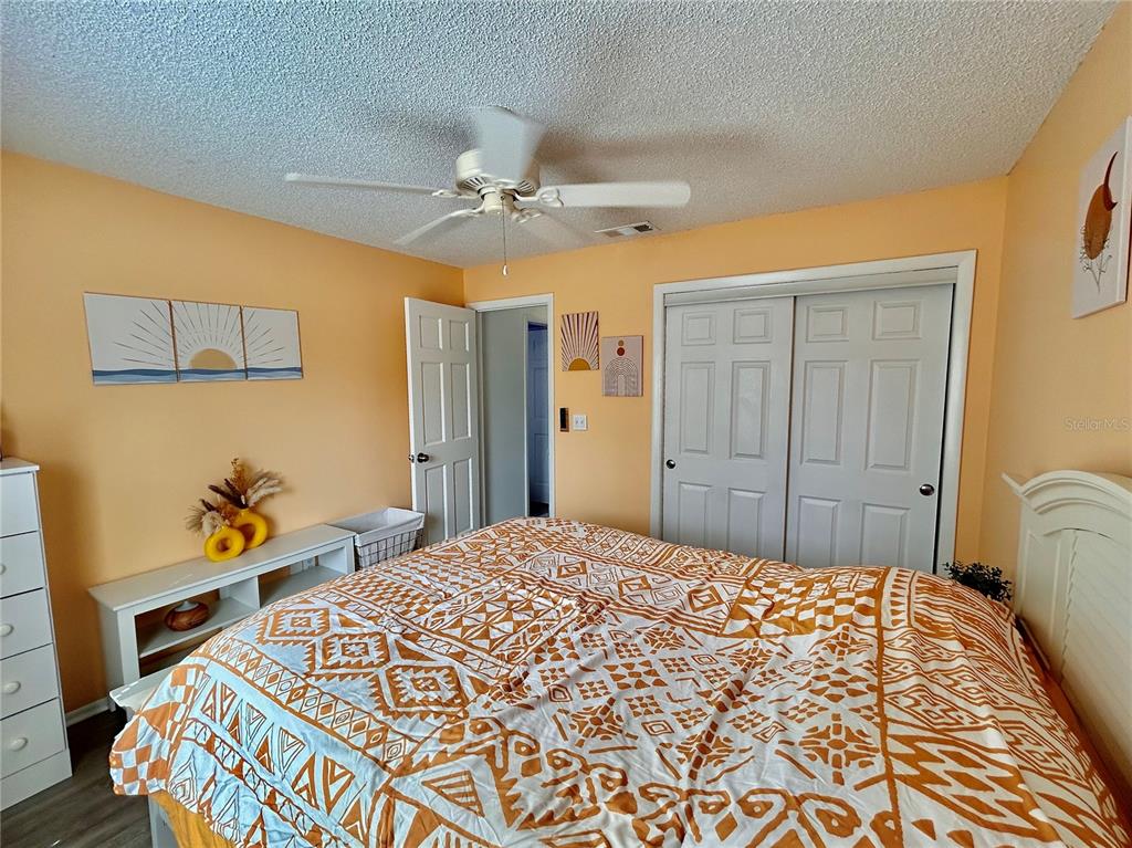 8911 Welsh Way Hudson, FL 34667 - Photo 26 of 33 a bedroom with a bed and a dresser