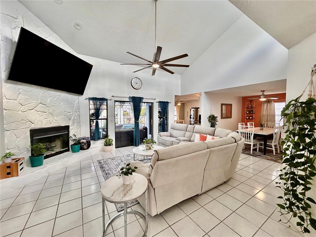 8911 Welsh Way Hudson, FL 34667 - Photo 3 of 33 a living room with furniture fireplace and a flat screen tv