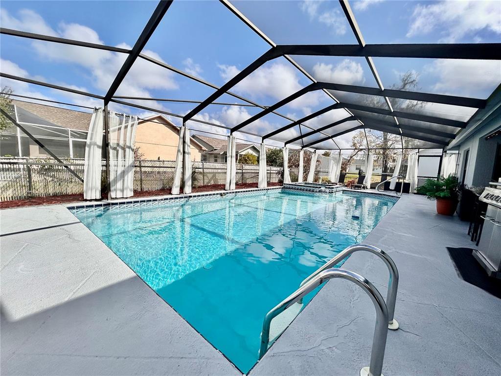 8911 Welsh Way Hudson, FL 34667 - Photo 31 of 33 a view of a swimming pool with a patio