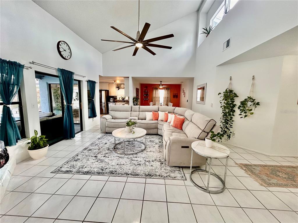 8911 Welsh Way Hudson, FL 34667 - Photo 5 of 33 a living room with furniture and a large window