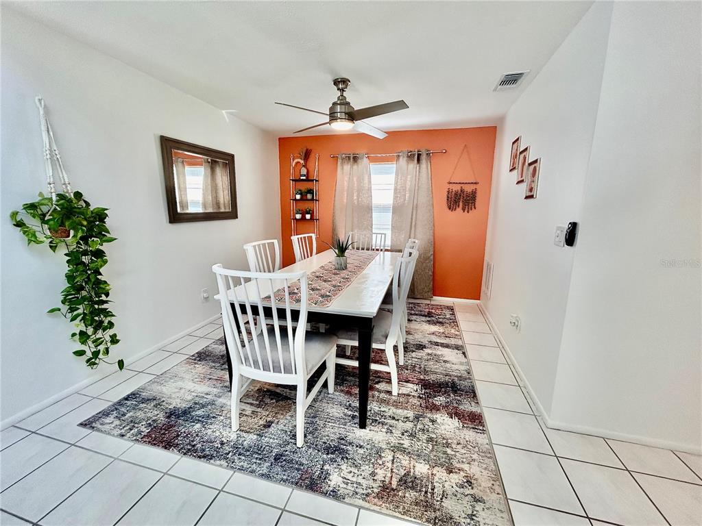 8911 Welsh Way Hudson, FL 34667 - Photo 7 of 33 a view of a dining room with furniture window and wooden floor