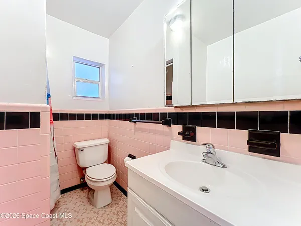 a bathroom with a sink a toilet and mirror