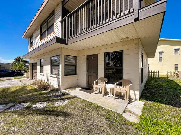 a view of a house with backyard and sitting area