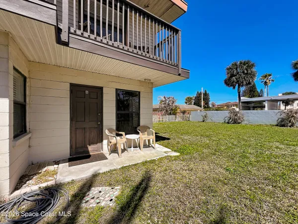 a view of a house with backyard porch and sitting area