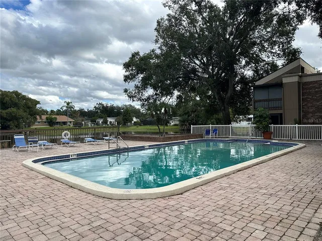a view of a swimming pool with a yard