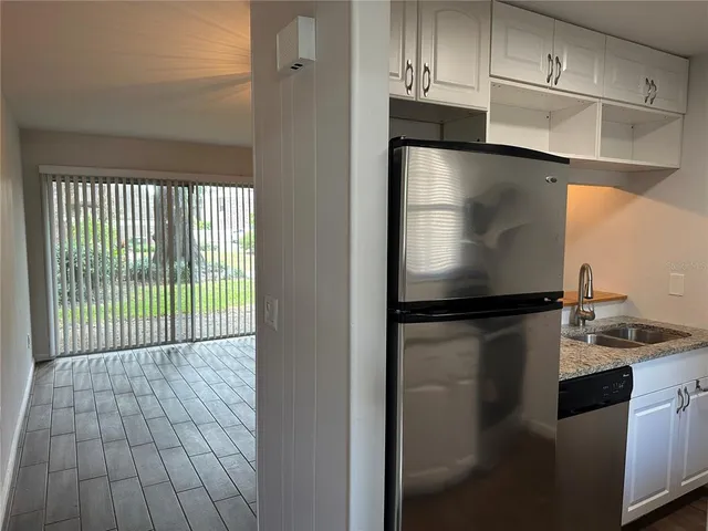 a refrigerator freezer sitting inside of a kitchen