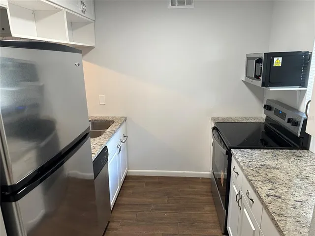 a kitchen with a stove and a refrigerator