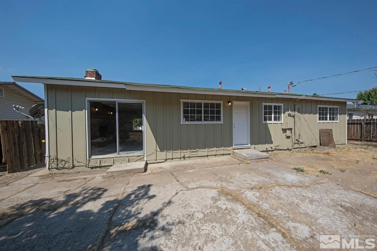 1230 Butler Street Reno, NV 89512 - Photo 18 of 21 a front view of a house with a yard and garage