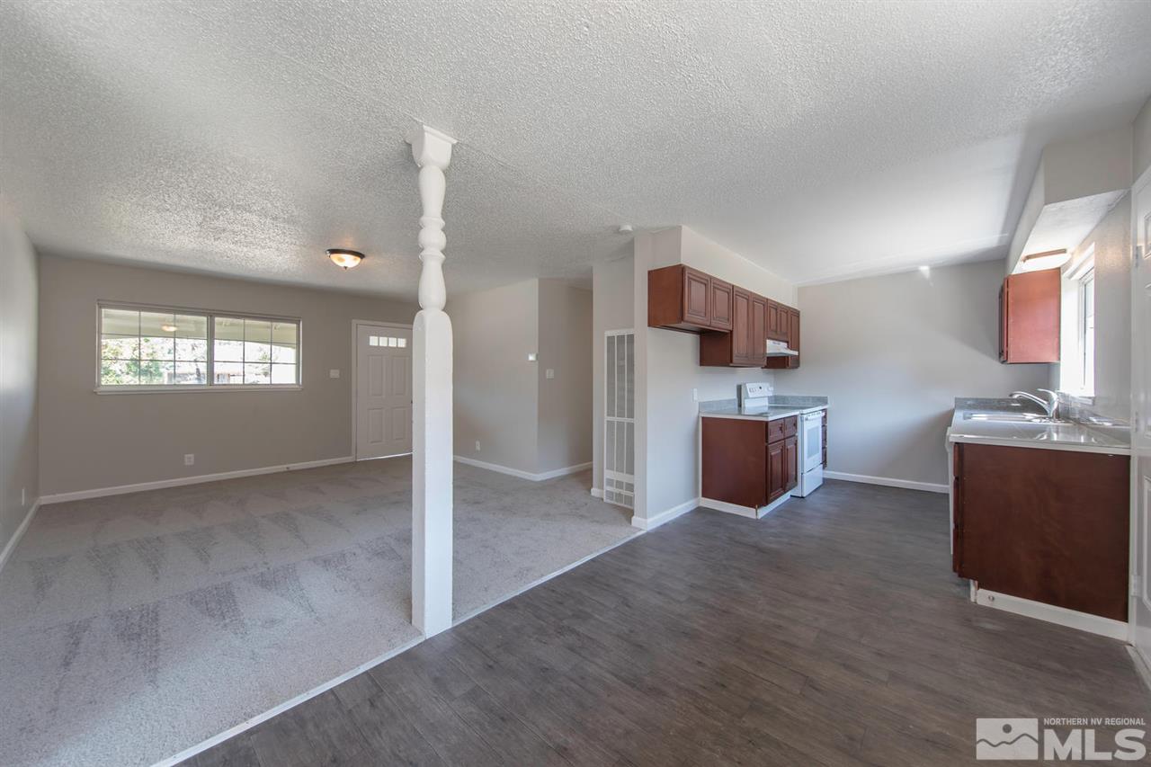 1230 Butler Street Reno, NV 89512 - Photo 6 of 21 a open kitchen with kitchen island wooden cabinets and stainless steel appliances