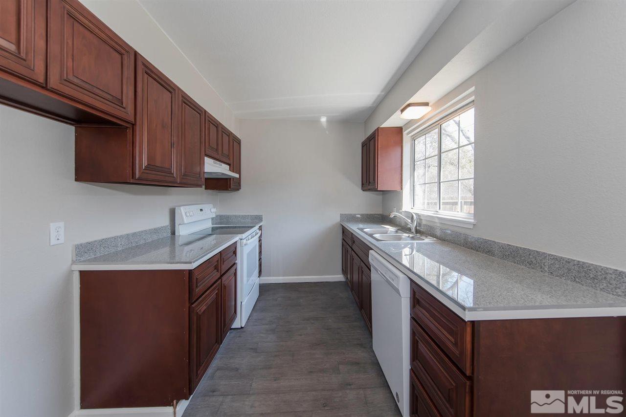 1230 Butler Street Reno, NV 89512 - Photo 7 of 21 a kitchen with stainless steel appliances granite countertop a sink stove and cabinets