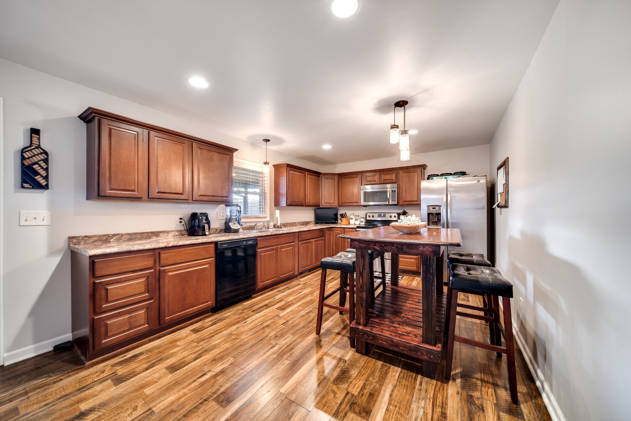 6862 Bethlehem Road Springfield, TN 37172 - Photo 16 of 60 a kitchen with stainless steel appliances granite countertop wooden floors a stove and a refrigerator