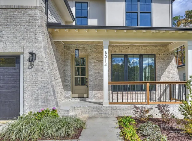a view of a brick house with large windows