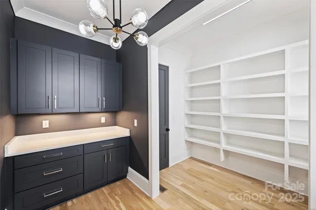a kitchen with a cabinets and chandelier