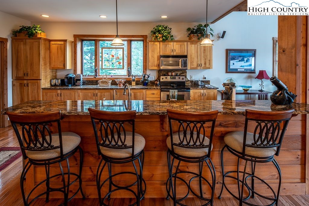 201 Pinnacle Ridge Road Beech Mountain, NC 28604 - Photo 12 of 26 a view of a dining room with furniture and chandelier