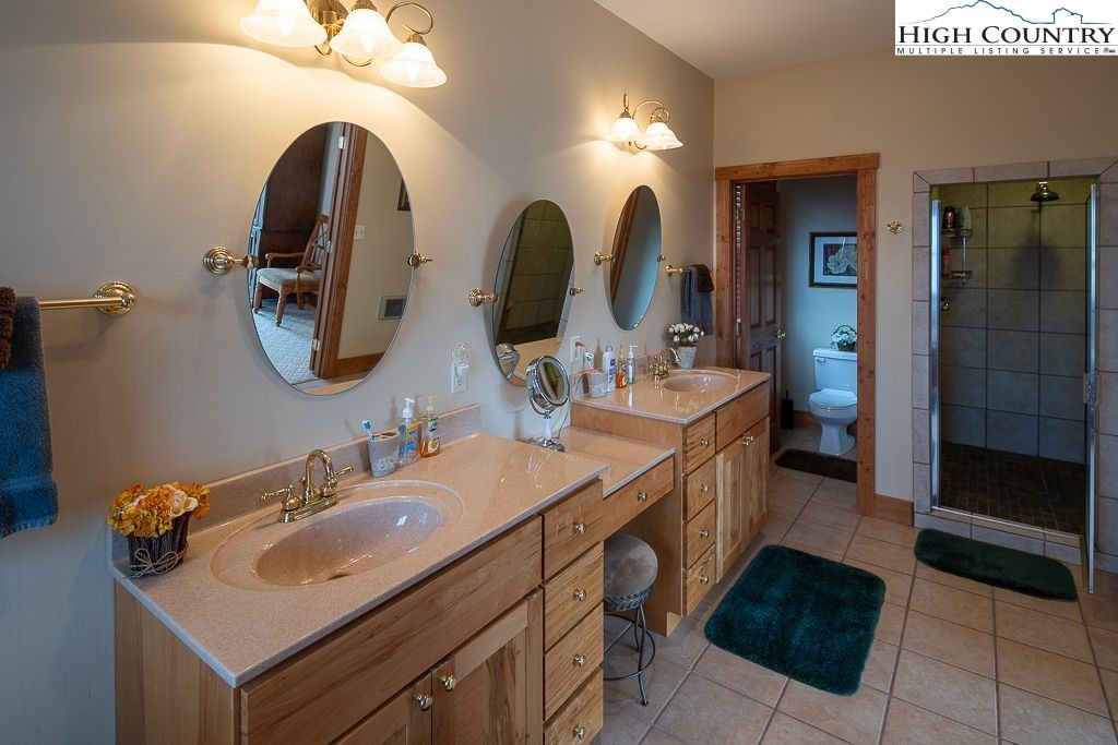 201 Pinnacle Ridge Road Beech Mountain, NC 28604 - Photo 20 of 26 a bathroom with a double vanity sink and a mirror