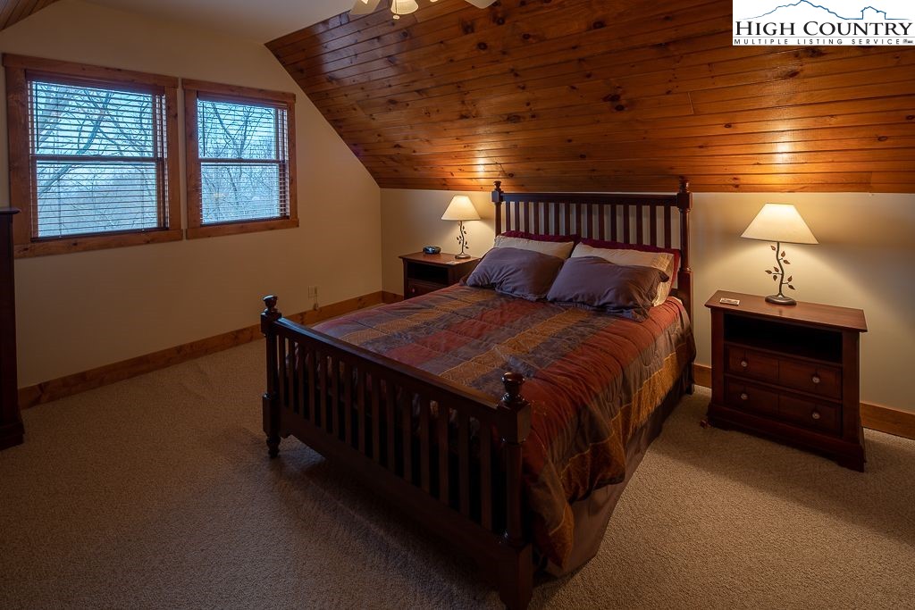 201 Pinnacle Ridge Road Beech Mountain, NC 28604 - Photo 23 of 26 a bedroom with a bed and a ceiling fan