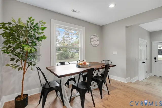 a view of a dining room with furniture and window