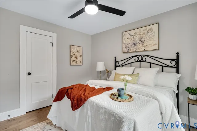 a bedroom with a bed and a large mirror