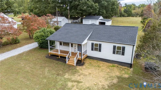 a aerial view of a house with swimming pool and sitting area