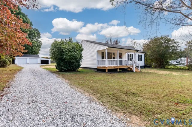 a view of a house with a yard and sitting area