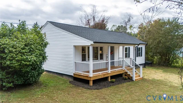 a view of a house with a yard and sitting area