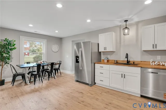 a large kitchen with sink and cabinets