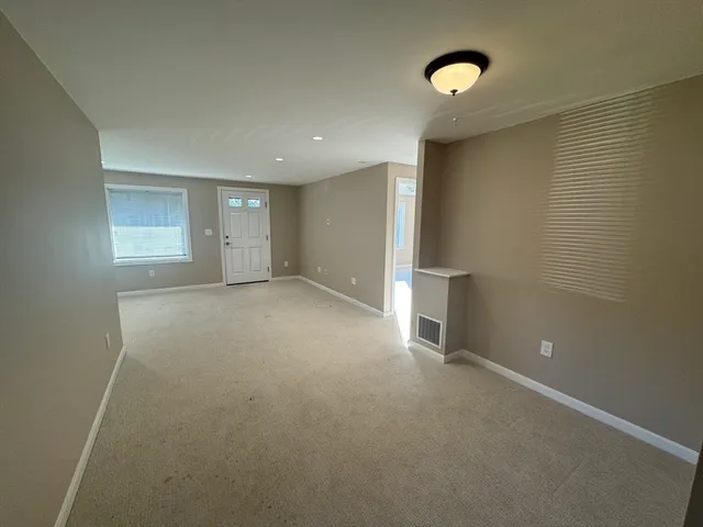 a view of hallway with windows and entryway