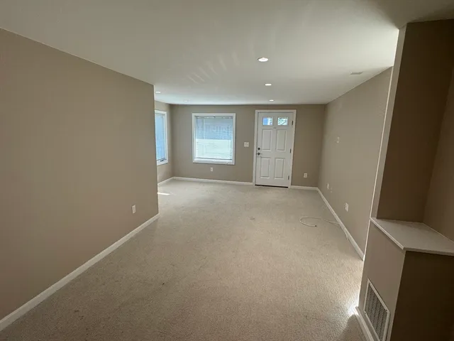 an empty room with windows and closet