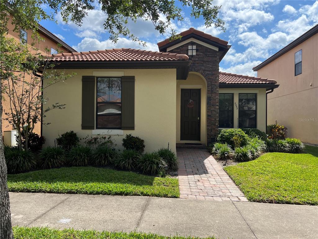 2002 Fishtail Fern Way Ocoee, FL 34761 - Photo 1 of 51 a view of a house with brick walls plants and large tree