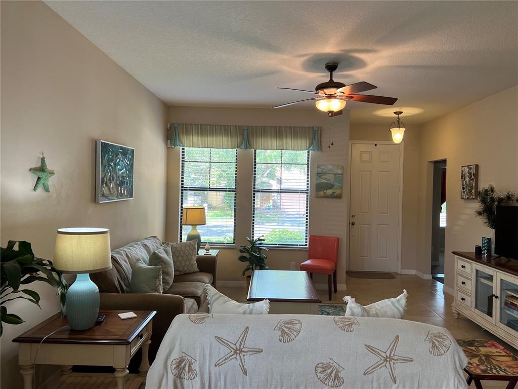 2002 Fishtail Fern Way Ocoee, FL 34761 - Photo 11 of 51 a living room with furniture a chandelier and a flat screen tv