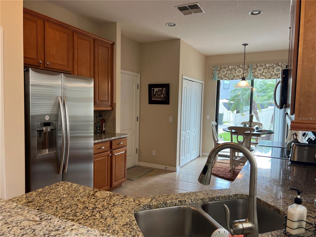 2002 Fishtail Fern Way Ocoee, FL 34761 - Photo 12 of 51 a kitchen with stainless steel appliances granite countertop a refrigerator a stove and a sink