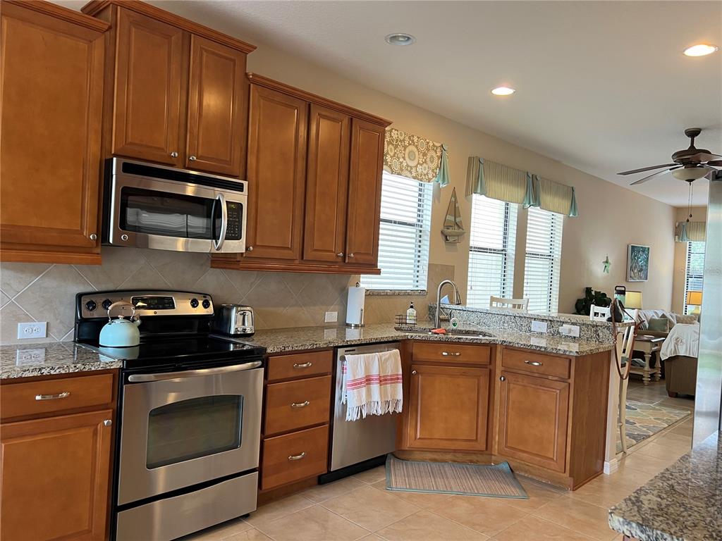 2002 Fishtail Fern Way Ocoee, FL 34761 - Photo 14 of 51 a kitchen with a stove microwave and sink