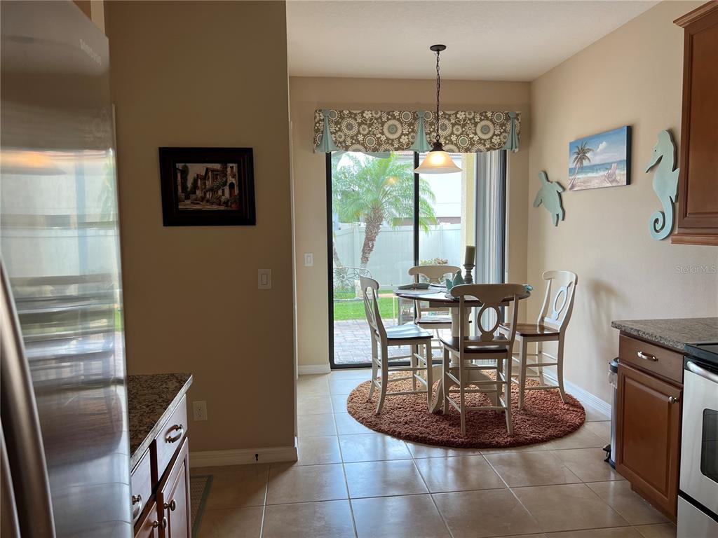 2002 Fishtail Fern Way Ocoee, FL 34761 - Photo 17 of 51 a dining room with furniture a chandelier and window