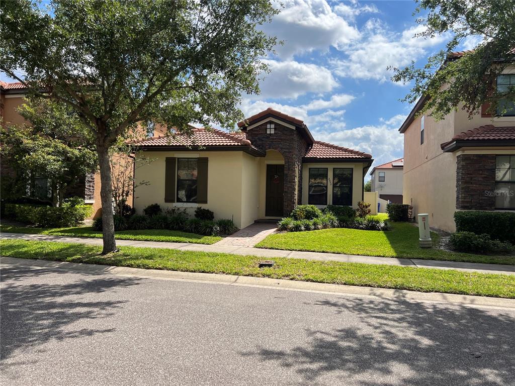 2002 Fishtail Fern Way Ocoee, FL 34761 - Photo 2 of 51 a view of yellow house with a big yard and large trees