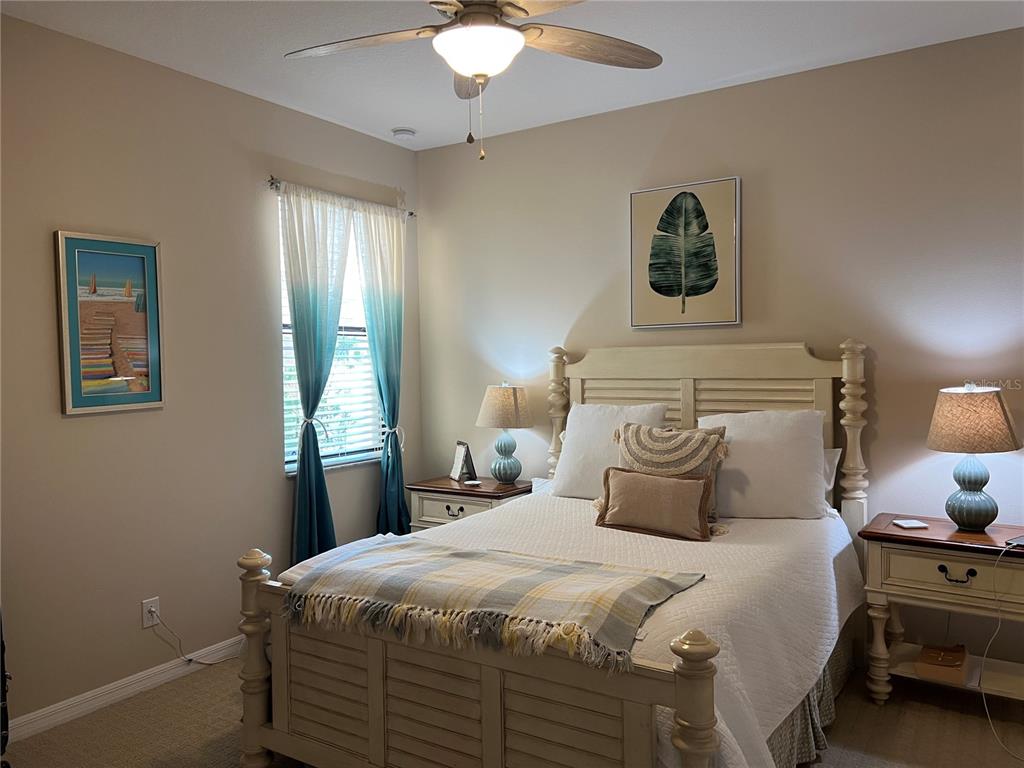 2002 Fishtail Fern Way Ocoee, FL 34761 - Photo 21 of 51 a bedroom with a bed and a chandelier