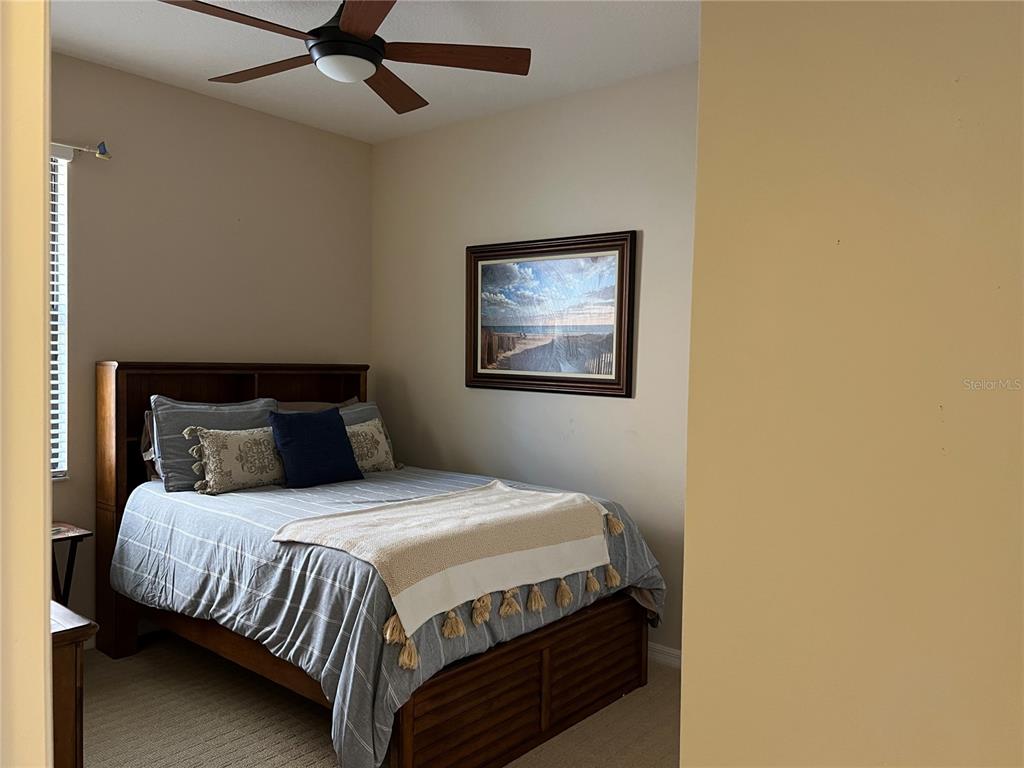 2002 Fishtail Fern Way Ocoee, FL 34761 - Photo 27 of 51 a bedroom with a bed and painting on the wall