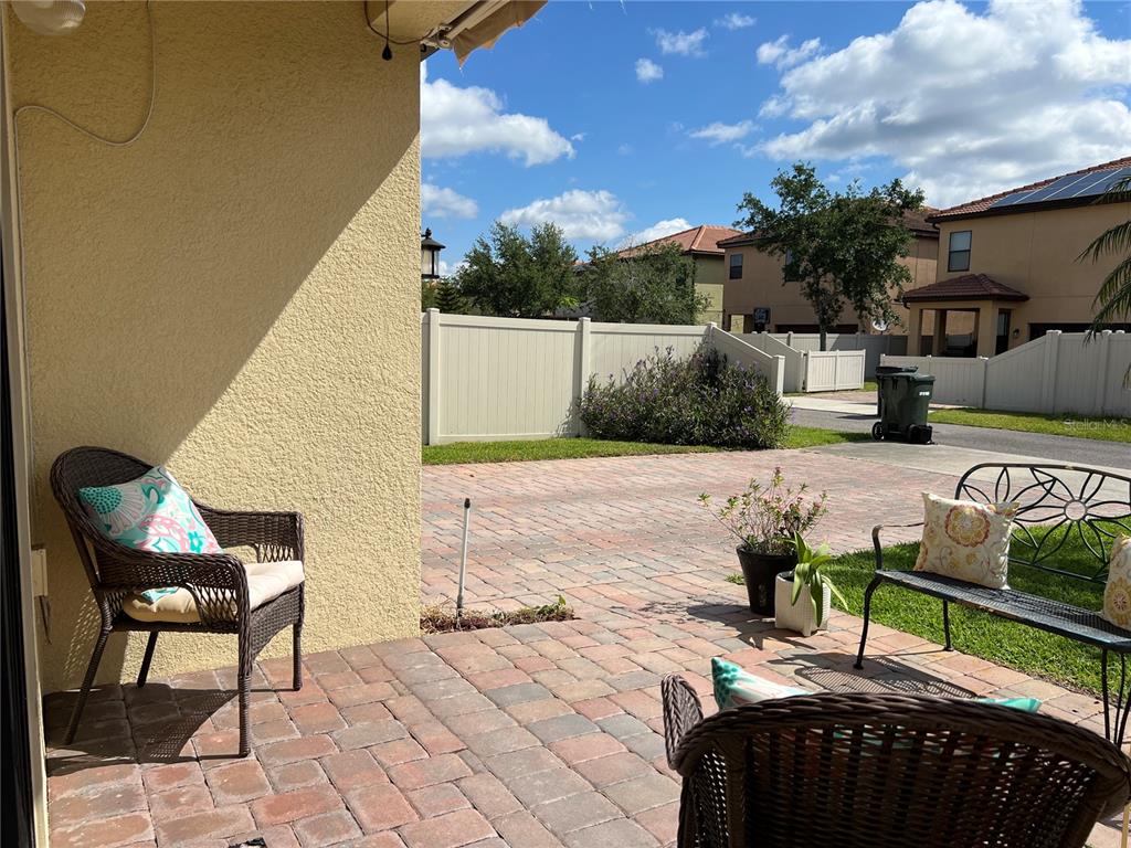 2002 Fishtail Fern Way Ocoee, FL 34761 - Photo 36 of 51 a view of a chairs and tables in the back yard of the house