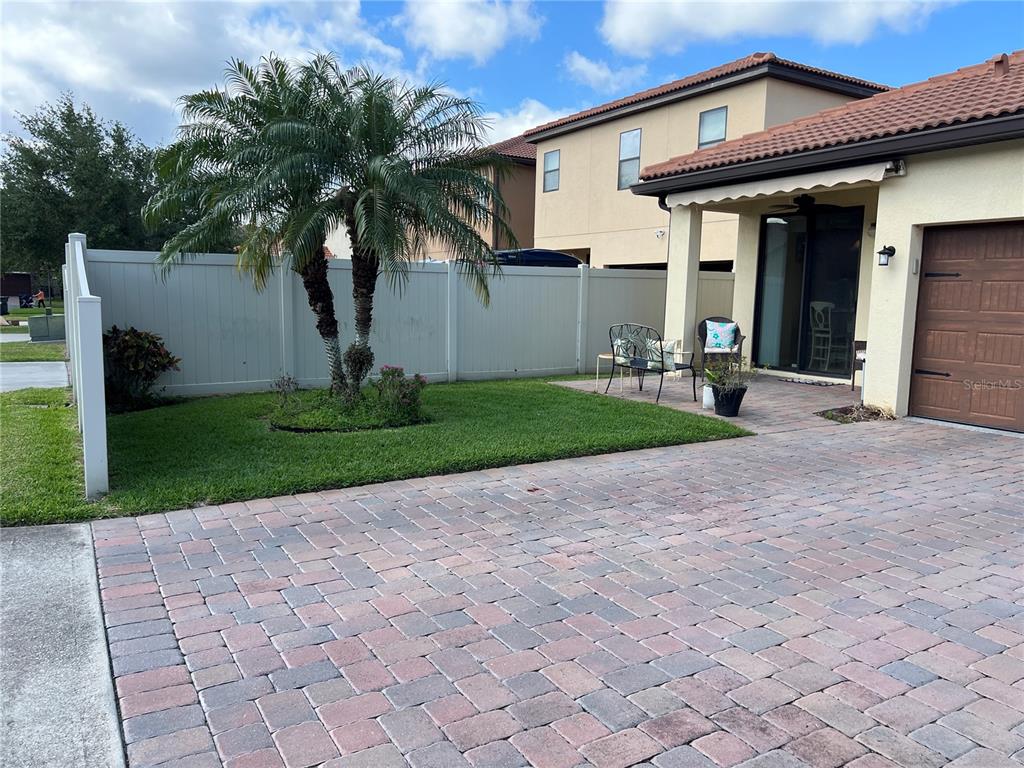 2002 Fishtail Fern Way Ocoee, FL 34761 - Photo 40 of 51 a front view of a house with a yard and potted plants