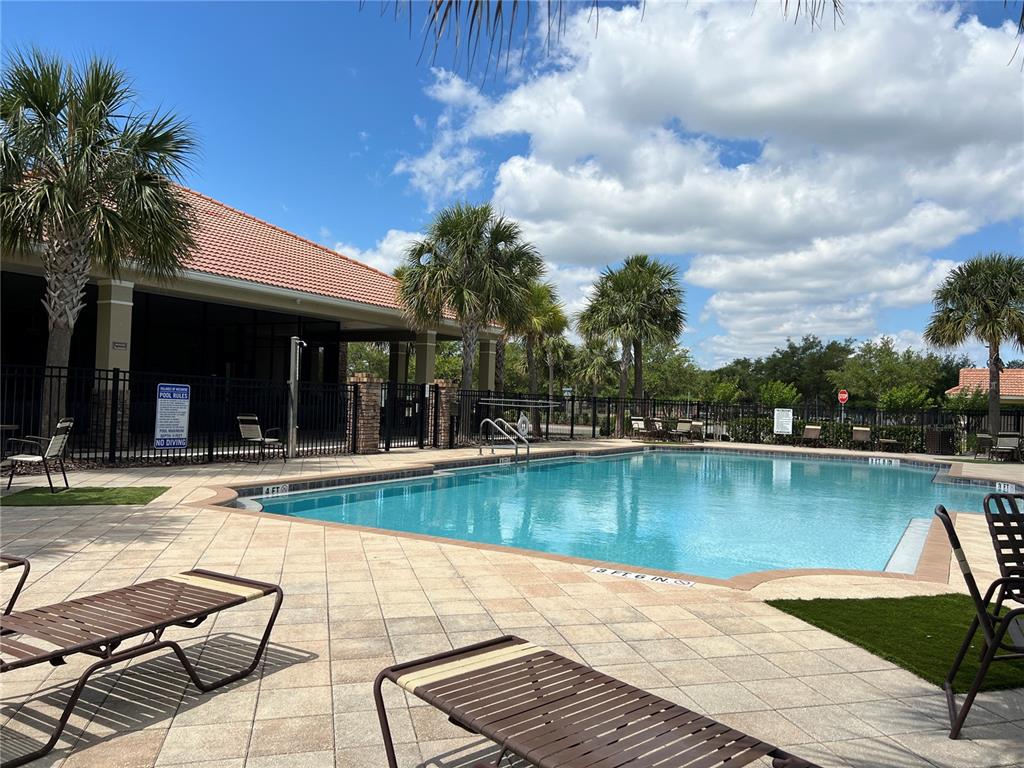 2002 Fishtail Fern Way Ocoee, FL 34761 - Photo 46 of 51 a view of a swimming pool with a lounge chairs
