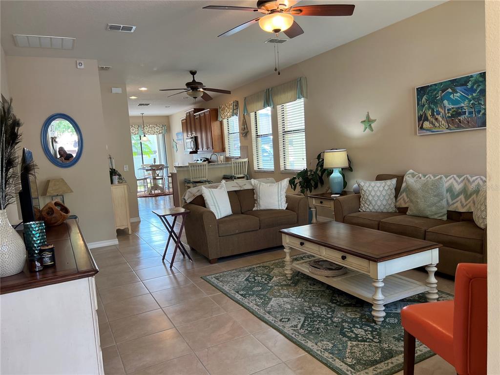 2002 Fishtail Fern Way Ocoee, FL 34761 - Photo 7 of 51 a living room with furniture a rug and a chandelier