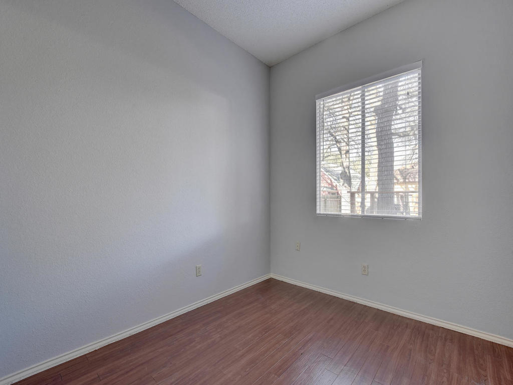 3019 Rochelle Drive Austin, TX 78748 - Photo 18 of 21 an empty room with wooden floor and windows
