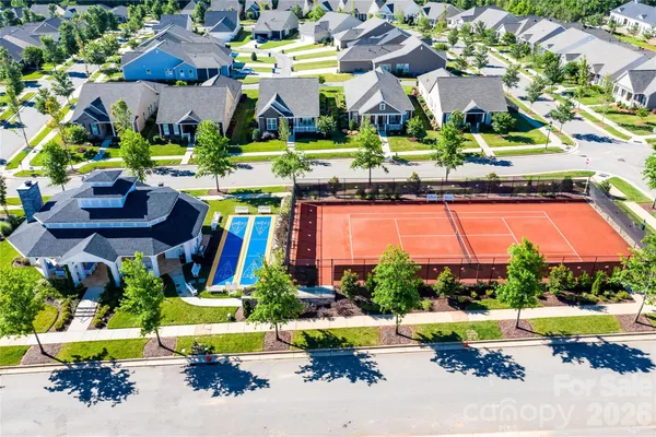 an aerial view of residential houses with outdoor space and swimming pool