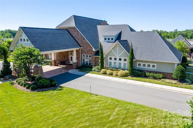 an aerial view of residential houses with outdoor space and parking