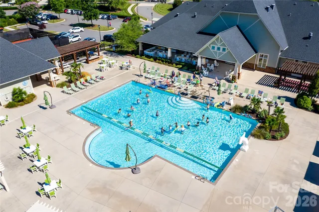 an aerial view of a pool patio fire pit and outdoor kitchen