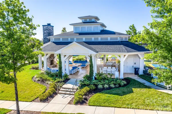 a backyard of a patio with swimming pool table and chairs