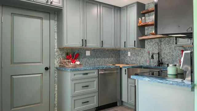 a kitchen with stainless steel appliances granite countertop a refrigerator sink and stove